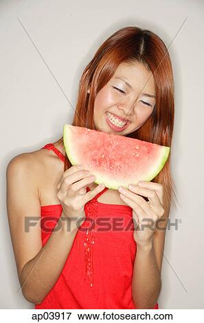 Woman holding a slice of watermelon View Large Photo Image Stock Photo - Woman holding a slice of watermelon. Fotosearch