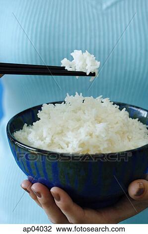 Woman holding bowl of rice and chopstick, close up View Large Photo Image Stock Image - Woman holding bowl of rice and chopstick, close up . Fotosearch