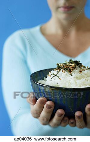 Woman holding bowl of rice, selective focus View Large Photo Image Stock Photograph - Woman holding bowl of rice, selective focus . Fotosearch