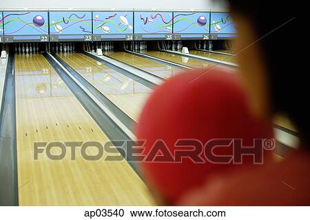 Woman holding bowling ball, preparing to bowl, over the shoulder view View Large Photo Image Stock Image - Woman holding bowling ball, preparing to bowl, over the shoulder view . Fotosearch