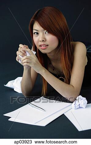 Woman holding crumpled paper in hands, looking at camera View Large Photo Image Stock Image - Woman holding crumpled paper in hands, looking at camera. Fotosearch