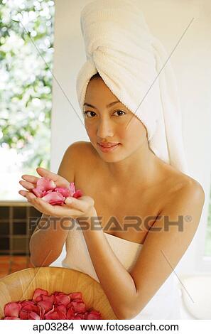Woman holding flower petals in cupped hands View Large Photo Image Picture - Woman holding flower petals in cupped hands . Fotosearch