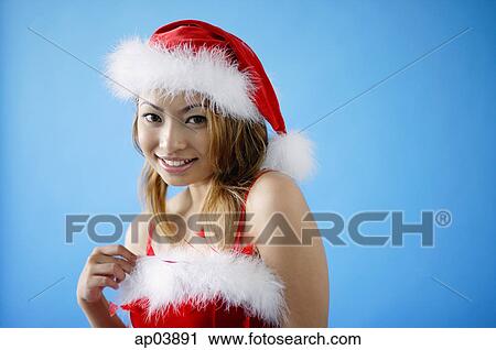 Woman in Santa hat and red dress View Large Photo Image Stock Image - Woman in Santa hat and red dress. Fotosearch