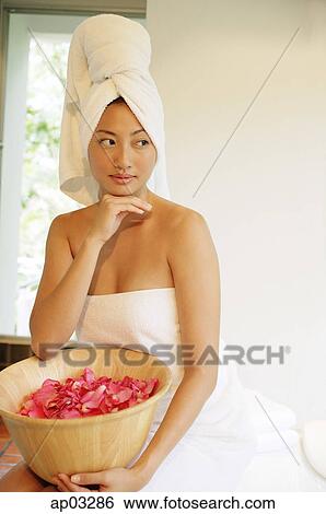 Woman in towel, holding bowl filled flower petals, hand on chin View Large Photo Image Stock Photograph - Woman in towel, holding bowl filled flower petals, hand on chin. Fotosearch