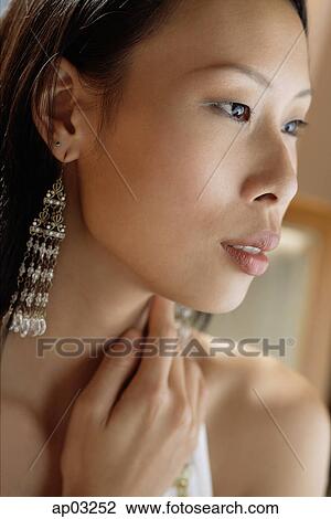 Woman looking away, hand on neck View Large Photo Image Stock Image - Woman looking away, hand on neck. Fotosearch