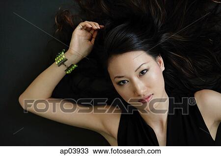 Woman lying on floor, looking at camera View Large Photo Image Stock Image - Woman lying on floor, looking at camera. Fotosearch