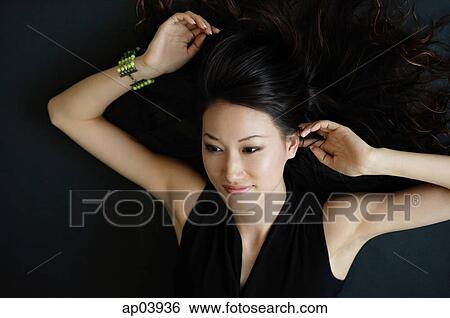 Woman lying on floor, smiling View Large Photo Image Stock Photograph - Woman lying on floor, smiling. Fotosearch