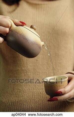 Woman pouring tea View Large Photo Image Picture - Woman pouring tea. Fotosearch