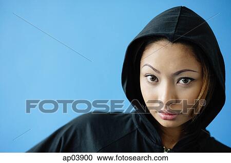 Stock Image - Woman wearing hooded shirt. Fotosearch