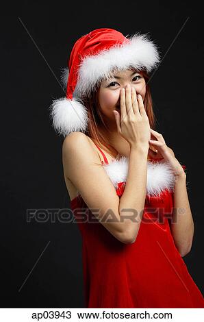 Woman wearing Santa hat and red dress, hand covering mouth View Large Photo Image Stock Image - Woman wearing Santa hat and red dress, hand covering mouth . Fotosearch