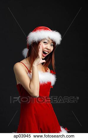 Stock Photography - Woman wearing Santa hat and red dress, shouting. Fotosearch