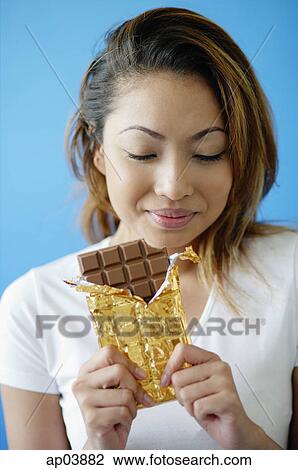 Woman with a bar of chocolate View Large Photo Image Stock Image - Woman with a bar of chocolate. Fotosearch