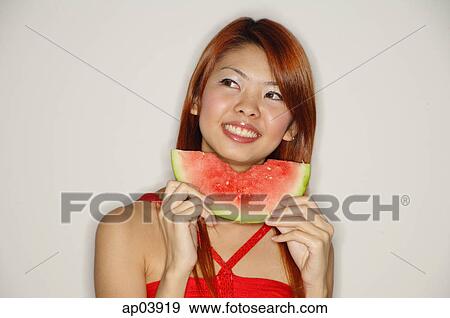 Stock Photo - Woman with a slice of watermelon, smiling . Fotosearch