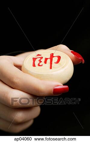 Womans hand holding one Chinese chess piece with Chinese script View Large Photo Image Stock Image - Womans hand holding one Chinese chess piece with Chinese script . Fotosearch