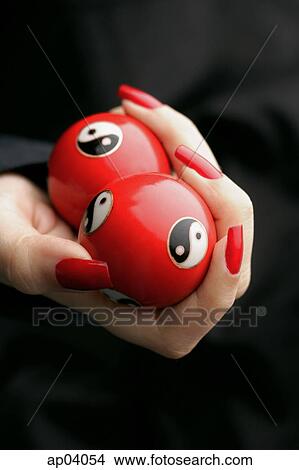 Womans hands with red nail polish, holding Yin Yang balls View Large Photo Image Picture - Womans hands with red nail polish, holding Yin Yang balls . Fotosearch