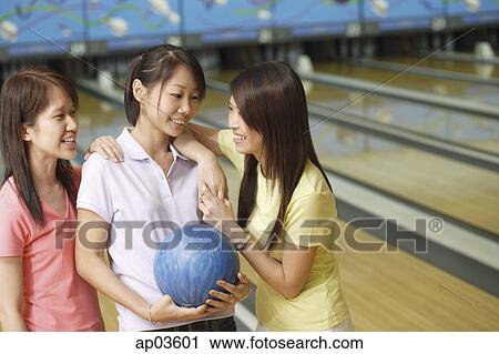 Stock Image - Women at bowling alley, talking . Fotosearch