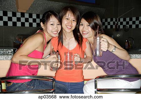 Women with drinks, smiling at camera View Large Photo Image Stock Photo - Women with drinks, smiling at camera . Fotosearch