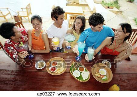 Young adults at beach bar, high angle view View Large Photo Image Stock Photo - Young adults at beach bar, high angle view . Fotosearch