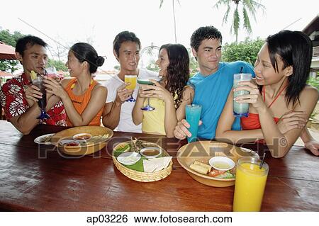 Young adults hanging out at beach bar View Large Photo Image Stock Photograph - Young adults hanging out at beach bar . Fotosearch