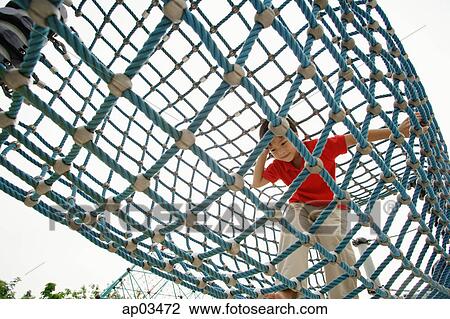 Young boy crawling through net tunnel View Large Photo Image Stock Image - Young boy crawling through net tunnel . Fotosearch