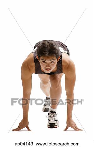 Young man bending in starting position, facing camera View Large Photo Image Stock Image - Young man bending in starting position, facing camera . Fotosearch