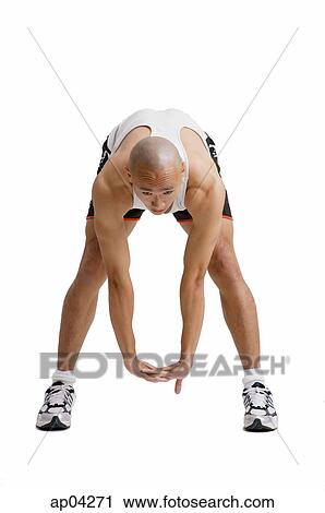 Young man bending over doing stretching exercise View Large Photo Image Stock Image - Young man bending over doing stretching exercise . Fotosearch