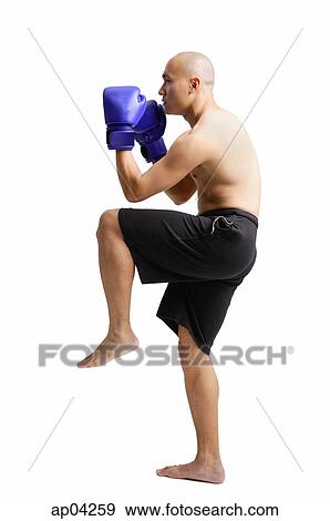 Stock Photo - Young man boxing, studio shot. Fotosearch