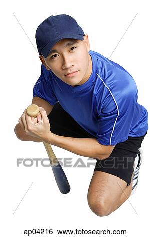 Young man crouching, holding baseball bat View Large Photo Image Stock Photograph - Young man crouching, holding baseball bat. Fotosearch