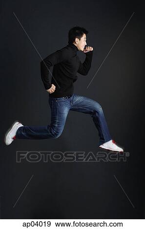 Young man dressed in black jumping in air View Large Photo Image Stock Photo - Young man dressed in black jumping in air. Fotosearch