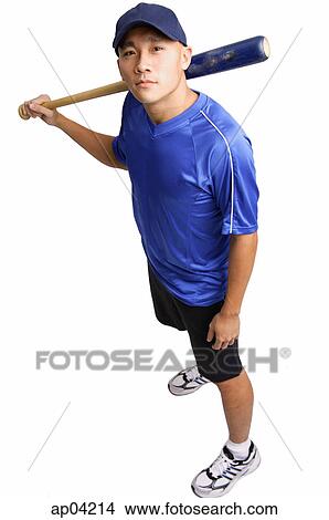 Young man holding baseball bat, looking up at camera View Large Photo Image Picture - Young man holding baseball bat, looking up at camera . Fotosearch