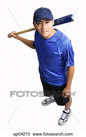Young man holding baseball bat, smiling up at camera View Large Photo Image Stock Photography - Young man holding baseball bat, smiling up at camera . Fotosearch