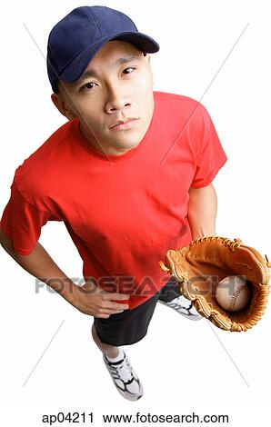 Young man holding baseball glove and ball, hand on hip View Large Photo Image Stock Image - Young man holding baseball glove and ball, hand on hip. Fotosearch