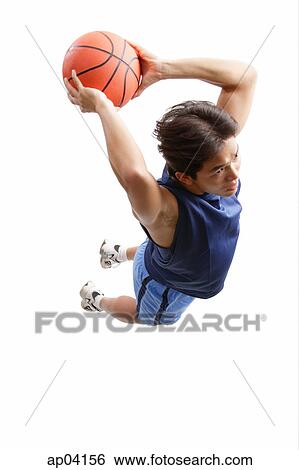 Young man holding basketball, jumping, preparing to shoot View Large Photo Image Stock Photograph - Young man holding basketball, jumping, preparing to shoot. Fotosearch