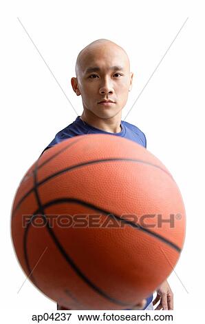 Young man holding basketball View Large Photo Image Stock Photo - Young man holding basketball . Fotosearch