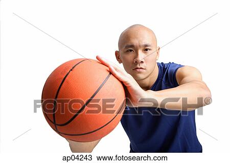 Young man holding basketball, towards camera View Large Photo Image Stock Image - Young man holding basketball, towards camera. Fotosearch