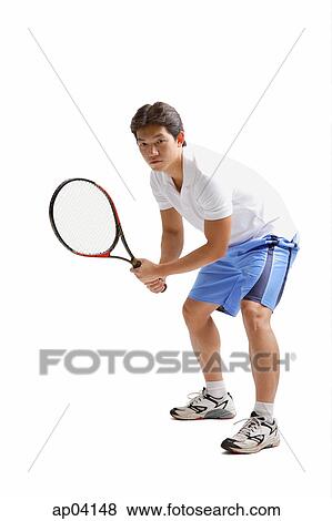 Stock Photo - Young man holding tennis racket . Fotosearch