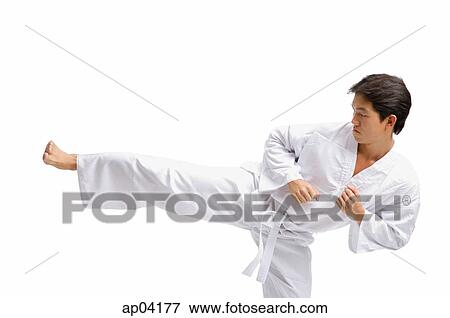 Young man in martial arts uniform, kicking View Large Photo Image Stock Photo - Young man in martial arts uniform, kicking . Fotosearch