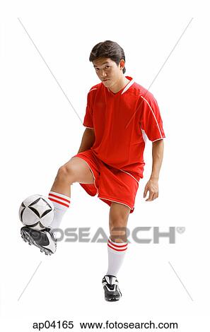 Young man in soccer uniform balancing soccer ball on leg View Large Photo Image Stock Photography - Young man in soccer uniform balancing soccer ball on leg. Fotosearch