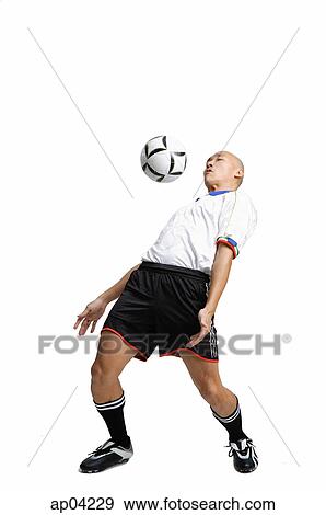 Young man in soccer uniform, hitting ball with his chest View Large Photo Image Stock Photo - Young man in soccer uniform, hitting ball with his chest. Fotosearch