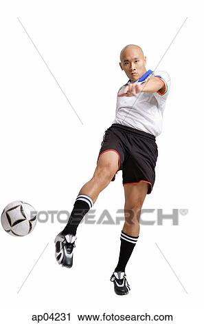 Young man in soccer uniform, kicking ball View Large Photo Image Stock Image - Young man in soccer uniform, kicking ball . Fotosearch