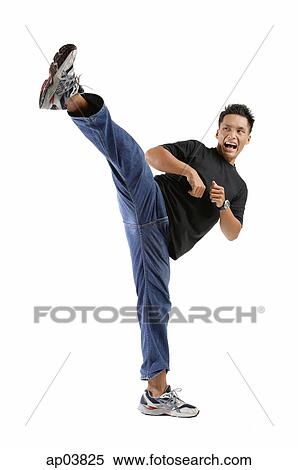 Young man kicking View Large Photo Image Stock Photography - Young man kicking. Fotosearch