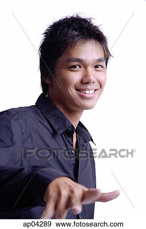 Young man looking at camera, smiling, head shot View Large Photo Image Stock Photo - Young man looking at camera, smiling, head shot . Fotosearch