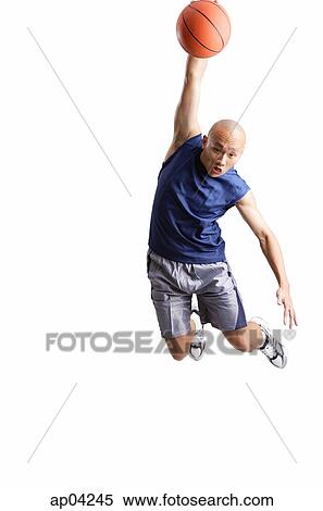 Young man making a slam dunk with basketball View Large Photo Image Stock Photography - Young man making a slam dunk with basketball. Fotosearch