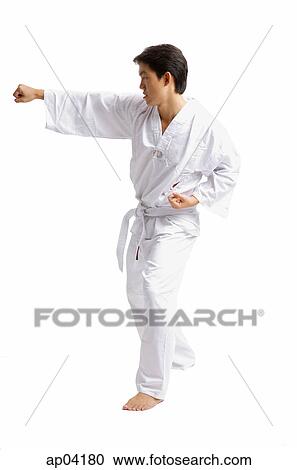 Stock Image - Young man practicing martial arts . Fotosearch