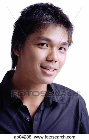 Stock Photo - Young man smiling at camera, head shot. Fotosearch