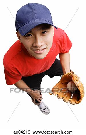 Young man wearing baseball glove and holding ball, high angle view View Large Photo Image Stock Image - Young man wearing baseball glove and holding ball, high angle view. Fotosearch