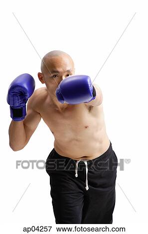 Young man wearing boxing gloves View Large Photo Image Stock Photo - Young man wearing boxing gloves. Fotosearch