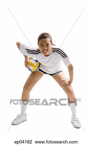 Young woman bending and holding volleyball View Large Photo Image Stock Image - Young woman bending and holding volleyball . Fotosearch