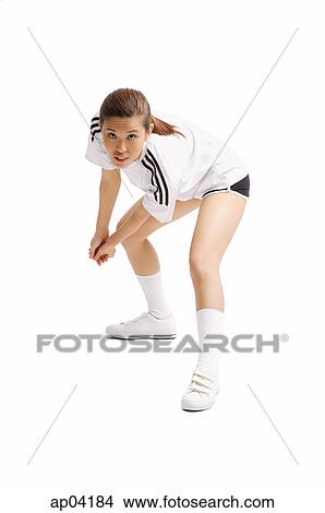 Young woman bending, hands clasped, waiting to hit ball View Large Photo Image Picture - Young woman bending, hands clasped, waiting to hit ball. Fotosearch