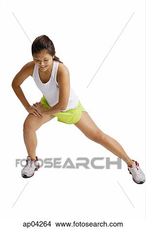 Young woman doing stretching exercises View Large Photo Image Picture - Young woman doing stretching exercises . Fotosearch